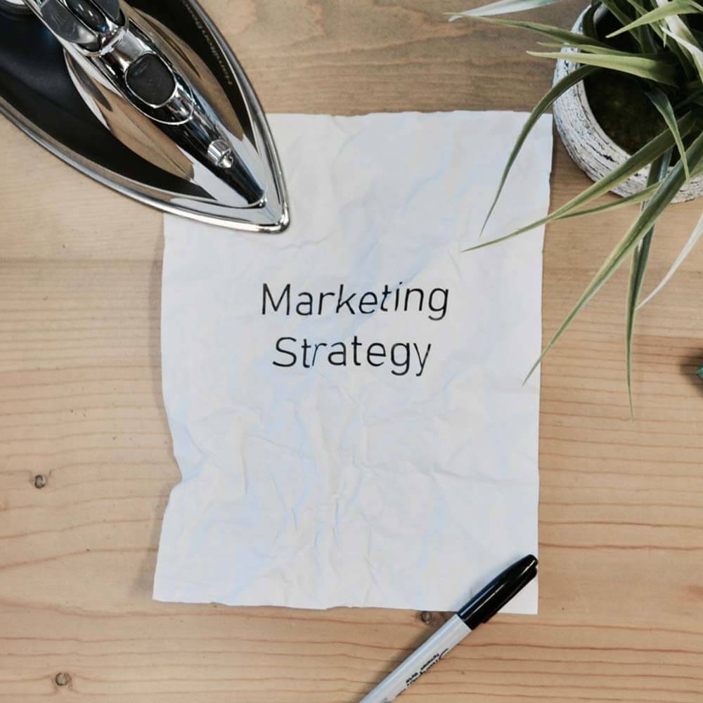 picture of a scrunched up paper with the words; marketing strategy on it