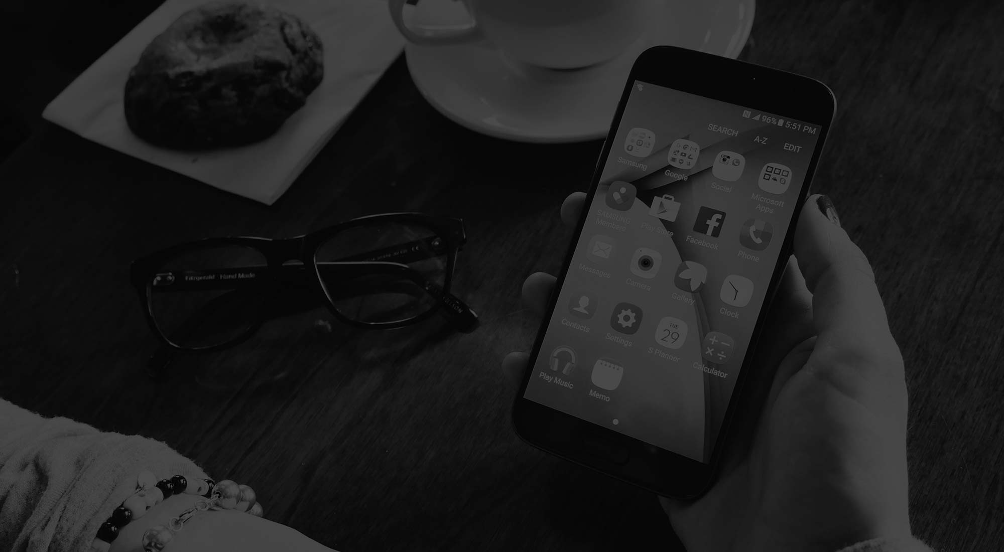 woman holding a mobile phone with apps on it