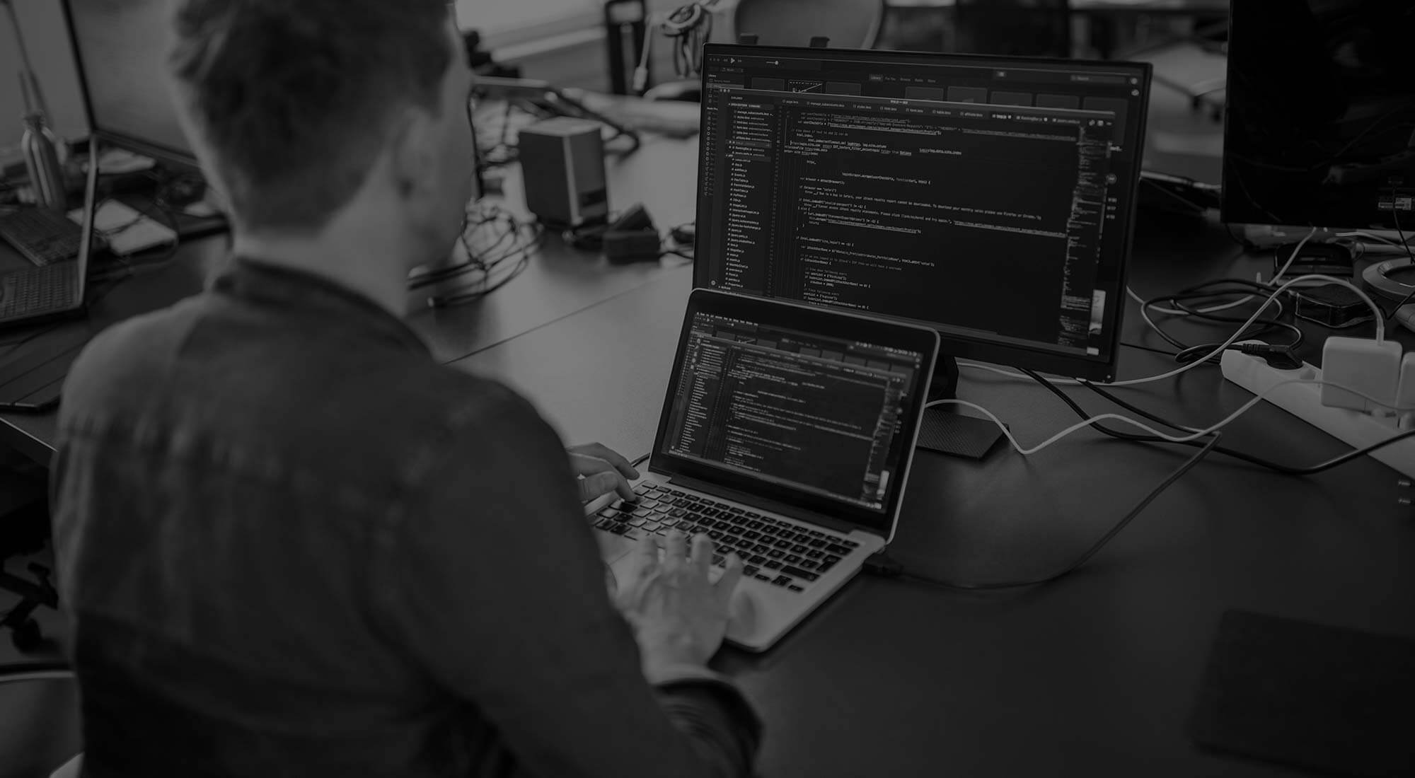 developer coding on macbook