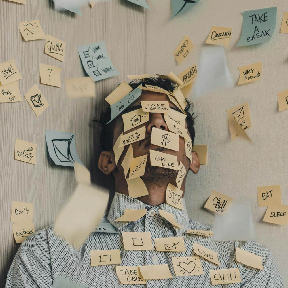 man in blue shirt covered with sticky notes